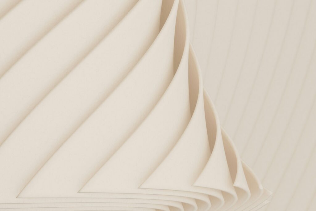 Abstrakte Darstellung von leicht aufgerollten Papierseiten.